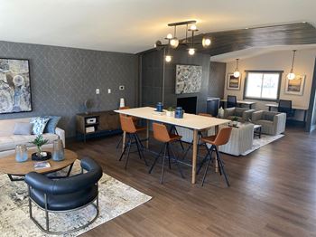 an open concept living room and dining room with a large table and chairs
